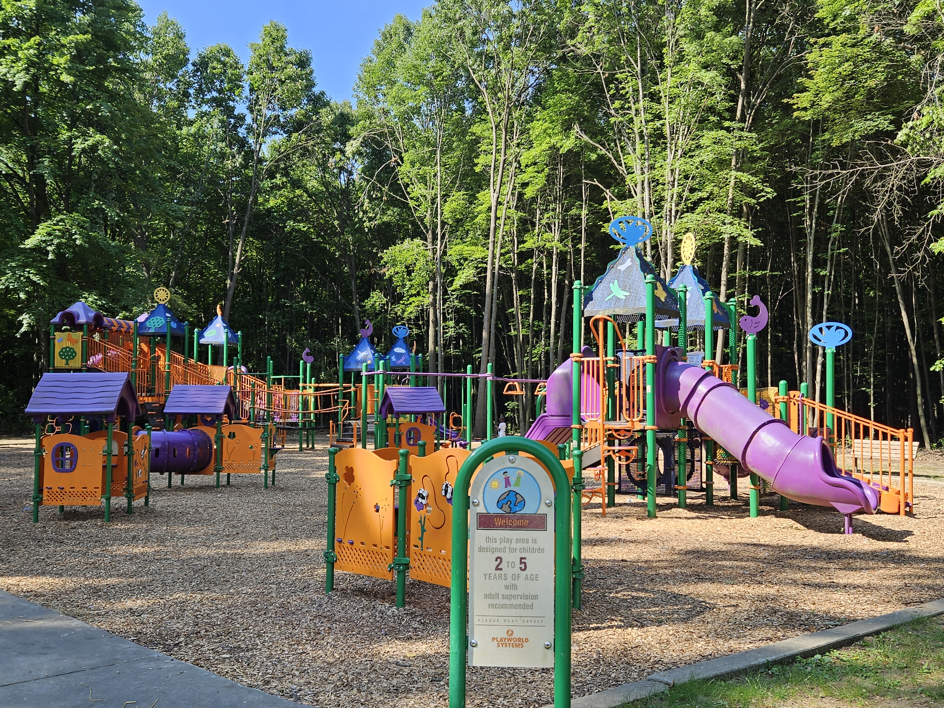 Brightly colored play equipment at Bauervic Woods Park