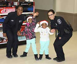 two young girls holding hands with police officers