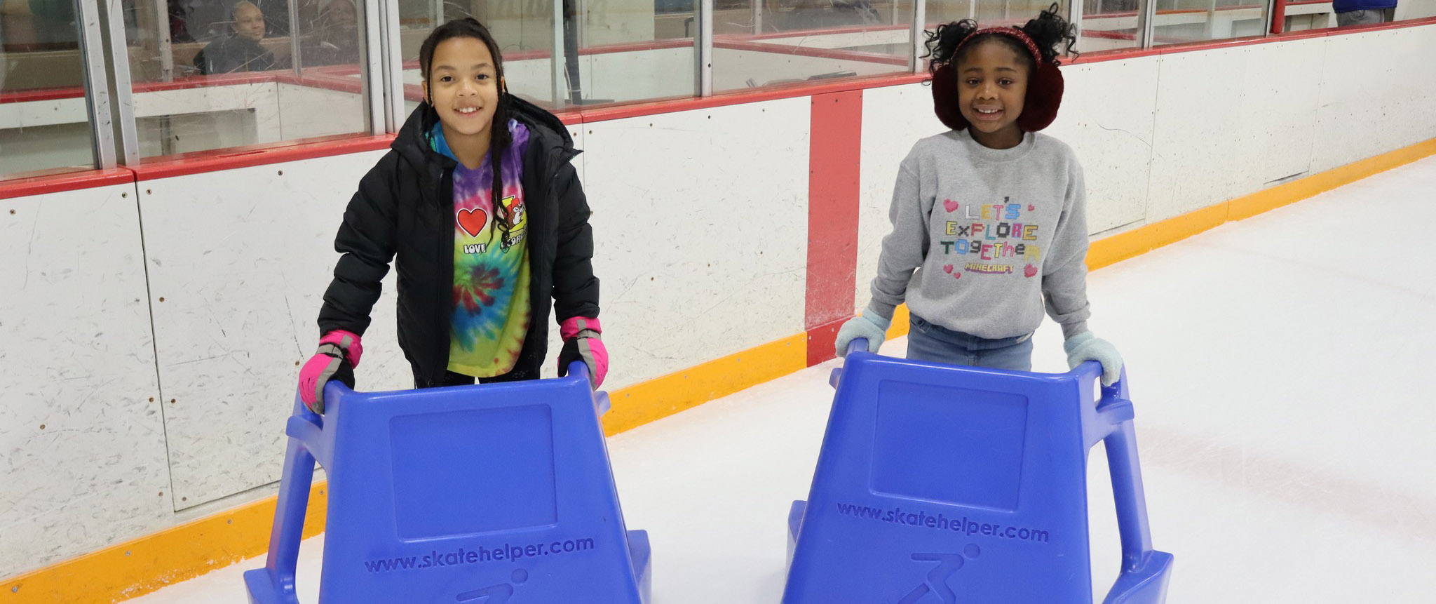 Photo of 2 girls with blue skate helpers at the Southfield Sports Arena