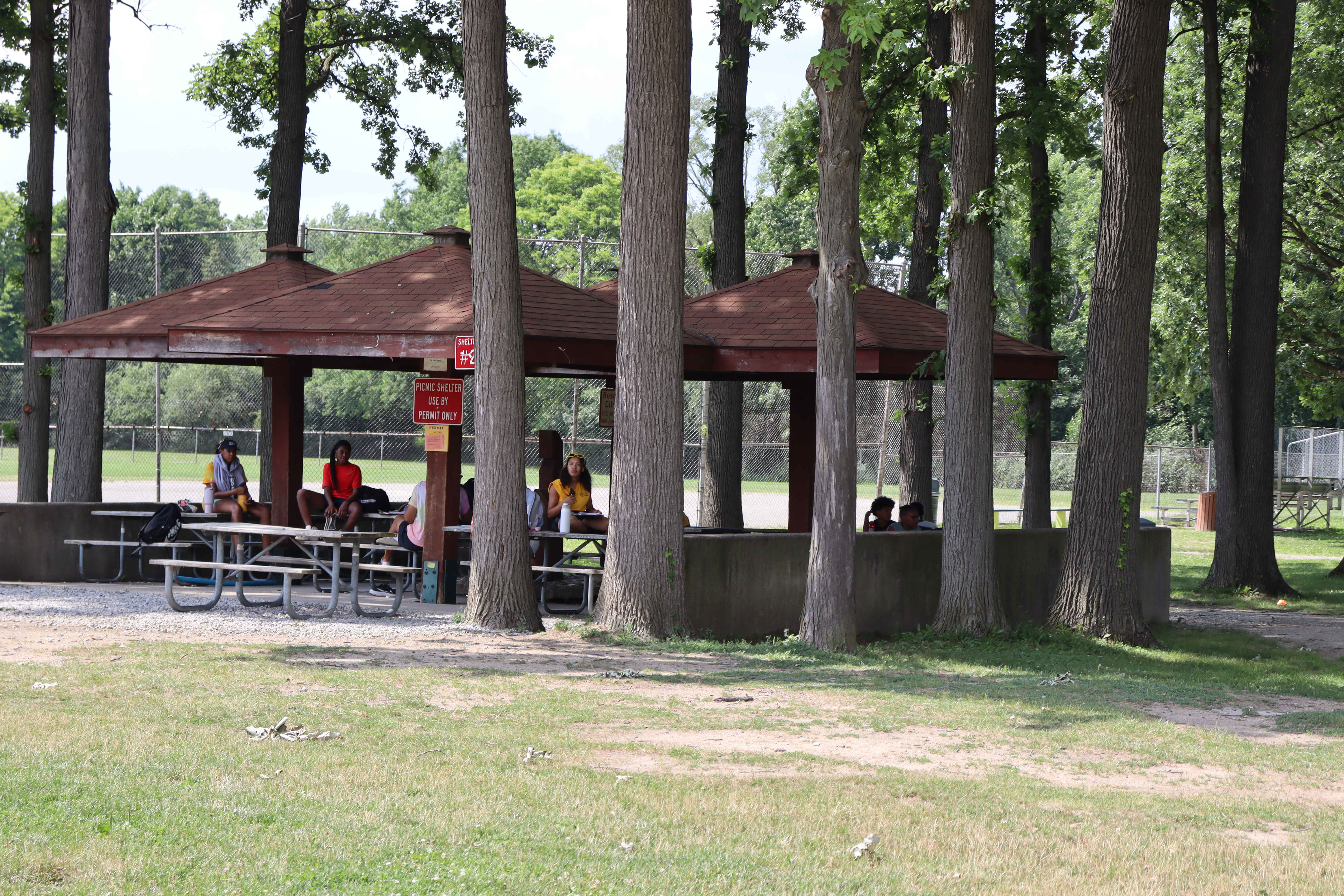 Civic Center Park Shelter #2, $100 per day, capacity 50 guests with 10 picnic tables. Weekend rentals only. Photos show the shelter near park ballfields and walking paths.