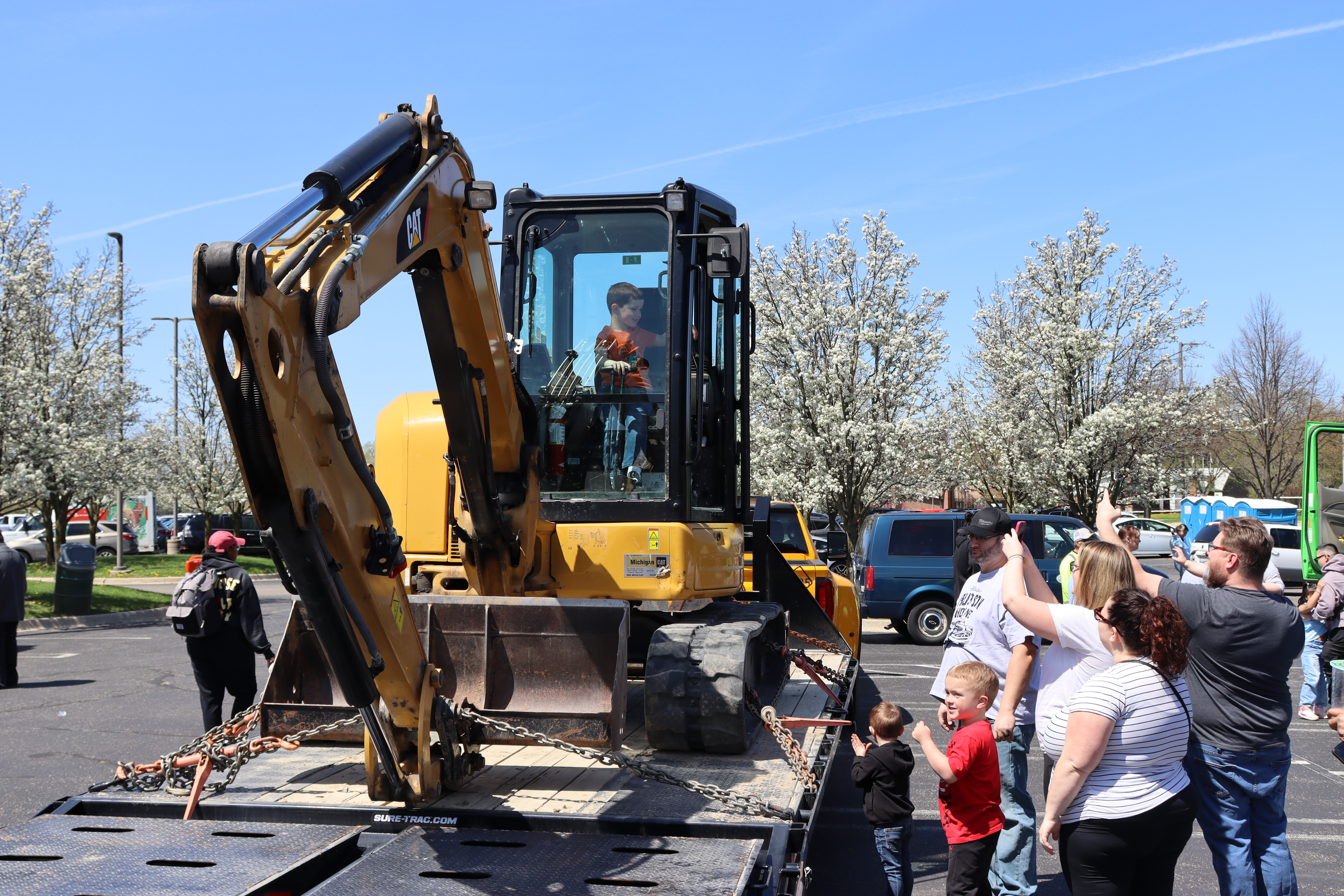 Children and families exploring an excavator at the 2024 Southfield Touch a Truck event at the Southfield Municipal Campus