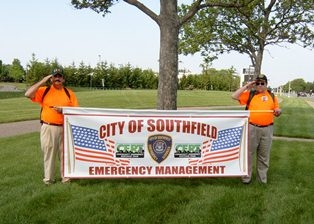 Two CERT Instructors hold up a "City of Southfield Emergency Management" banner