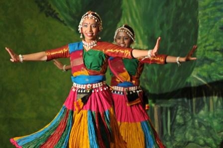 Two women dancing in colorful clothing