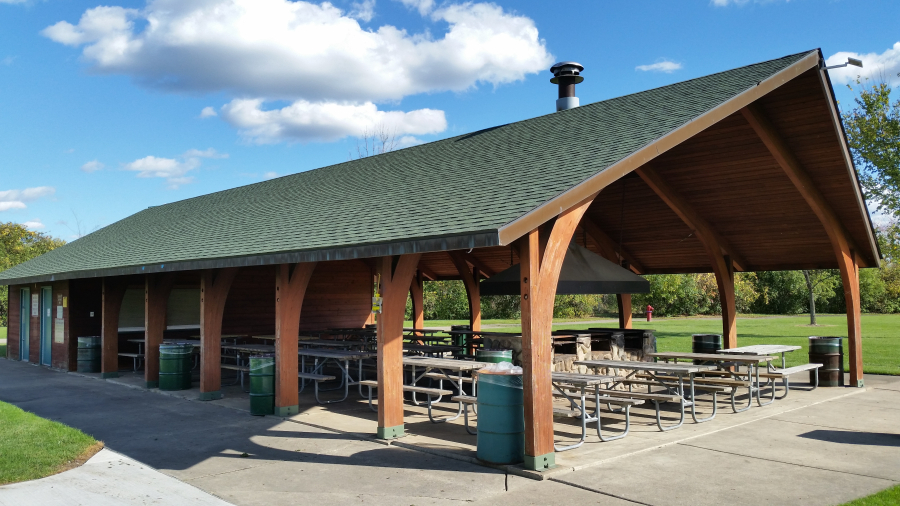 Pebble Creek Park Shelter, $275 per day, capacity 150 guests with 18 picnic tables. Photos show the shelter located northwest of the park near the playground.